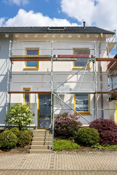 Stock image House with scaffolding with blue sky background