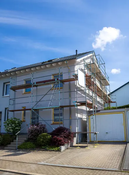 stock image House with scaffolding with blue sky background