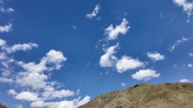 Serene Güzeli Yeşil Çimen, Beyaz Kabarık Bulutlar ve Açık Mavi Gökyüzü 'nün nefes kesici 4K manzarası. Büyüleyici Doğa Stoku, Görüntü, Hava, Panorama