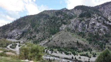 Serenity Breathaway with Crystal River, Lush Trees, Majestic Rocks, Winding Road Side View with Car, Turbulent Clouds, and Riverbed with Stones & Trees, Perfect for Nature Lovers, 4k