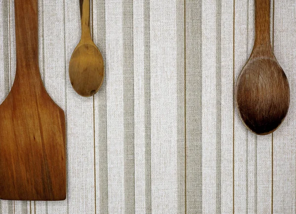 wooden spoon and spatula on fabric background