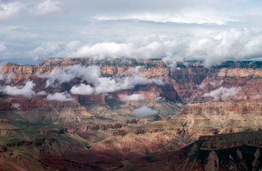 Low lying clouds and fog brings out the glorious muted colors, ridges and textures at this lovely Grand Canyon scene. clipart