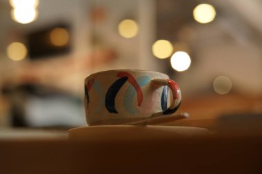 A unique cup from the ground that contains coffee latte