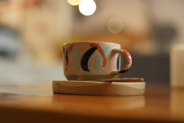 A unique cup from the ground that contains coffee latte