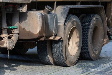 Fuel tank and tires of an old truck.