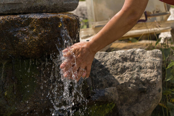 Washing hands in the plateau with water from the mountain in Turkey