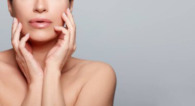 Beauty and Skin Care Concept. Beautiful natural woman with flawless fresh clean skin. Panorama banner with lateral grey copyspace