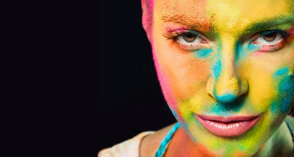 Mysterious sensual woman covered in rainbow colored powder used to celebrate the colors Holi festival. Beauty spring concept