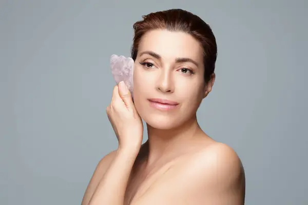 Elegant Woman Utilizes Heart Shaped Gua Sha Stone Rejuvenating Facial Stock Photo