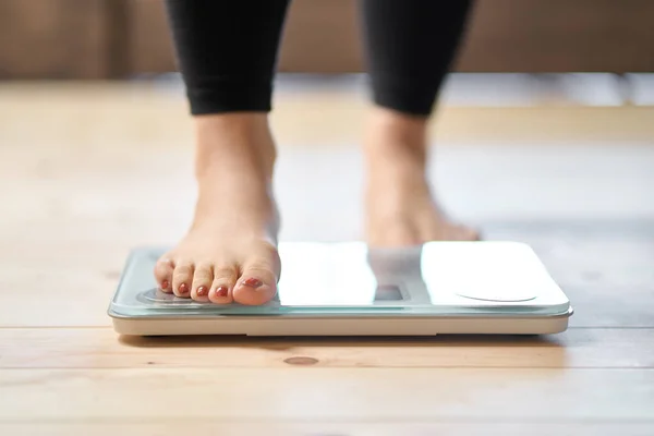 stock image Feet of an Asian woman on a weight scale