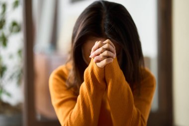 woman praying with her hands folded clipart