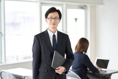 Asian businessman with tablet in seminar room