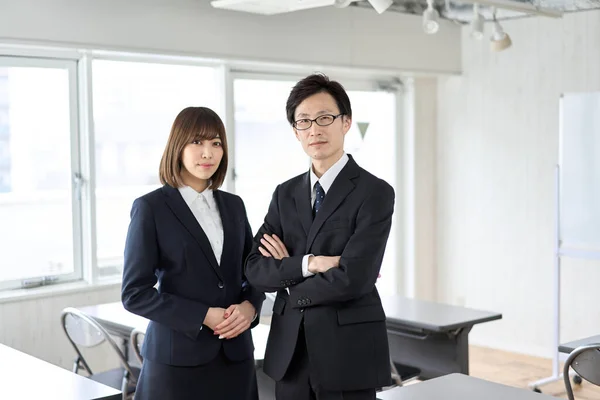 Asian business person standing in seminar room