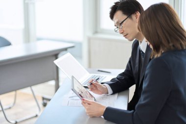 Asian business person having a meeting with a tablet