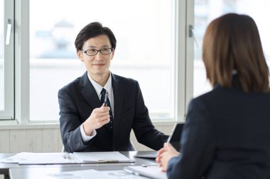 Asian business person praising his subordinate