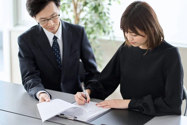 Asian woman signing a contract