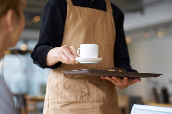 Asian male clerk working at a cafe