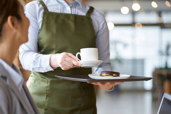 Asian female clerk working at a cafe