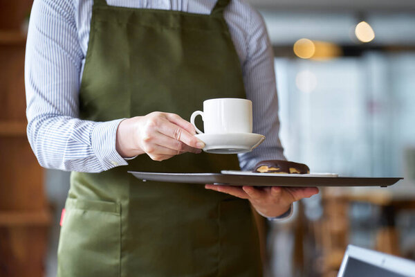Asian female clerk working at a cafe