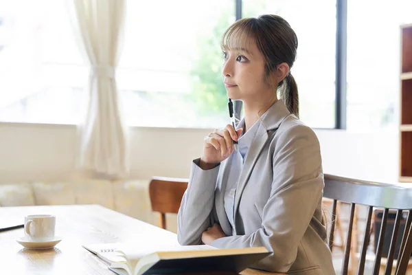 Business woman thinking while studying