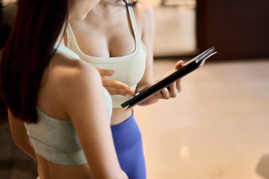 Trainer deciding on a training plan using a tablet