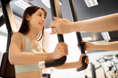 Woman training her chest muscles with a pectoral fly machine