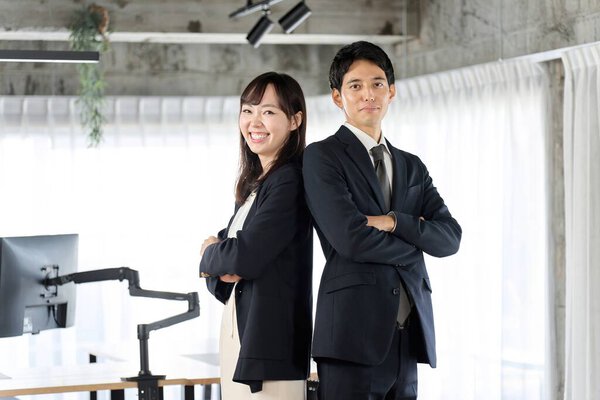 Business person standing with arms folded