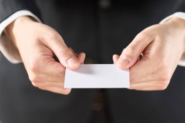 Kartvizit tutan bir iş adamının eli.