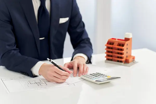 Businessman calculating the floor plan of an apartment
