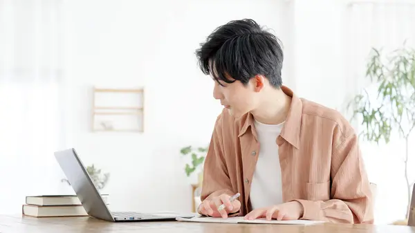 stock image A man studying for a qualification at home