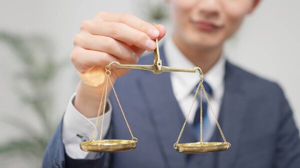 Asian businessman holding a scale
