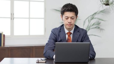 bir dizüstü bilgisayarda yazarak işadamı