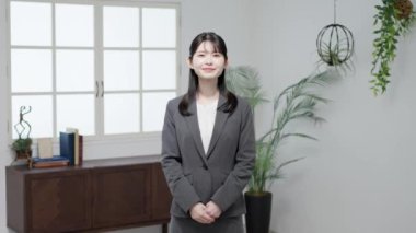 Asian business woman standing with a smile