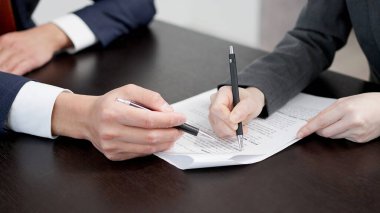 Businesswoman's hands checking a contract clipart