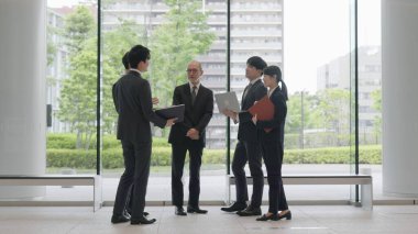 Business people talking in the lobby clipart