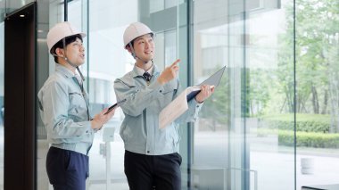 A man in work clothes having a meeting clipart