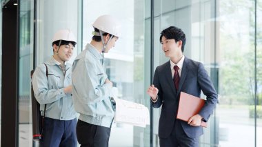 A man in work clothes having a meeting with a client clipart