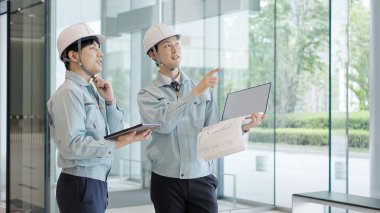 A man in work clothes having a meeting clipart