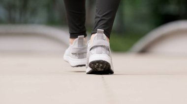 Feet of a walking woman clipart