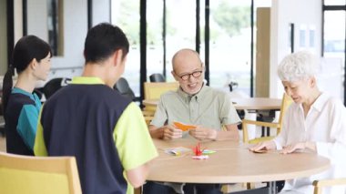 Elderly Asian people folding origami in a care facility