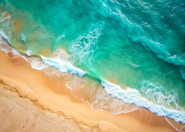 The concept of rest and travel. Beautiful background. Top view of the white sand beach and the rolling foamy wave of the turquoise ocean.