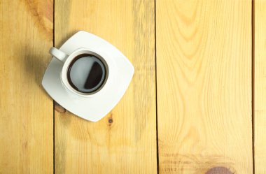 cup with coffee on a wooden table made of pine boards