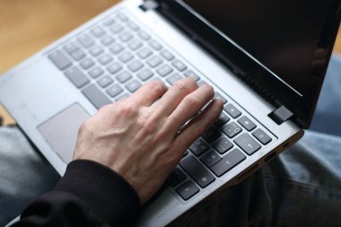 person is typing on a laptop keyboard