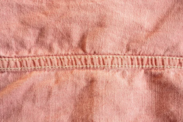 stock image Fabric background in pink color with stitches. Copy space. Flatley. Close-up.