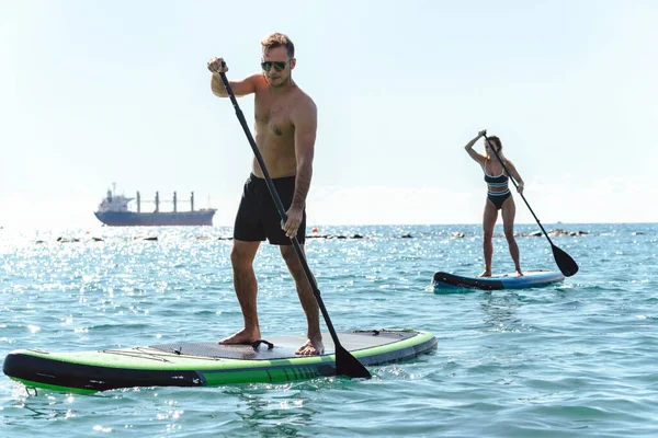 Couple Young Male Female Surfers Riding Standup Paddleboards Together Rowing — Stock Photo, Image