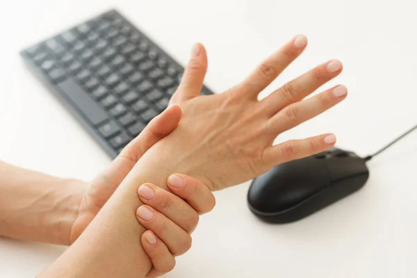 stock image Closeup of female hands with a pain in the wrist because of carpal tunnel syndrome 