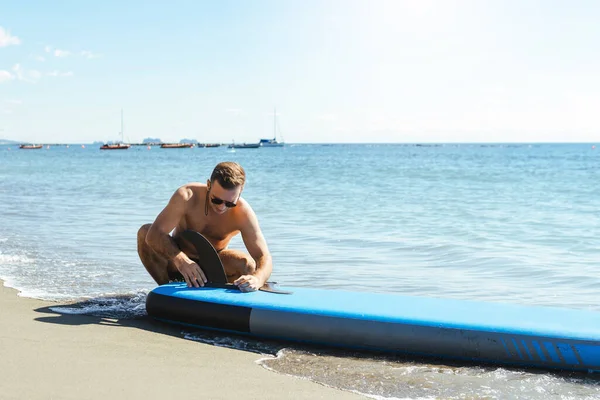 Mladý Surfař Připravuje Podstavec Pro Jízdu Písečné Pláži Poblíž Oceánu — Stock fotografie