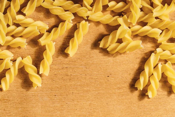 Closeup Uncooked Fusilli Pasta Wooden Background — Stock Photo, Image