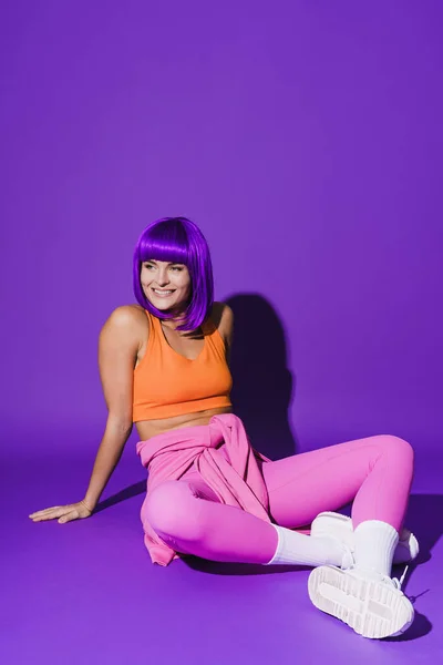 Portrait Cheerful Woman Wearing Colorful Sportswear Sitting Purple Background — Stock Photo, Image