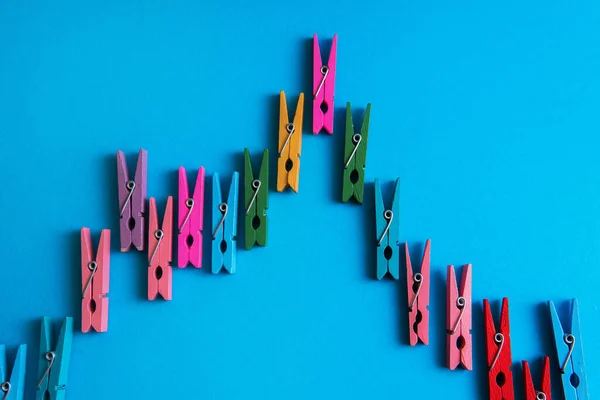 Closeup Shot Financial Graph Made Colorful Wooden Clothespins Blue Background — Stock Photo, Image